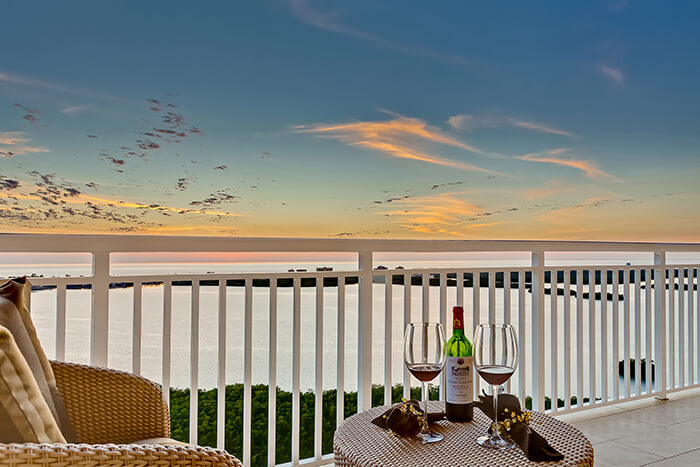 Balcony overlooking the ocean with a bottle of wine and two glasses